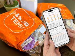 Someone looking at the Temu return policy on a phone next to their Temu order