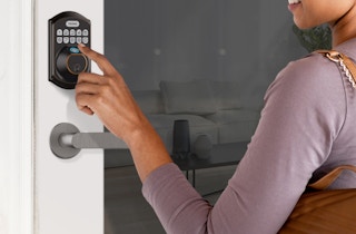 person using the a teeho keyless fingerprint keypad deadbolt lock on a door