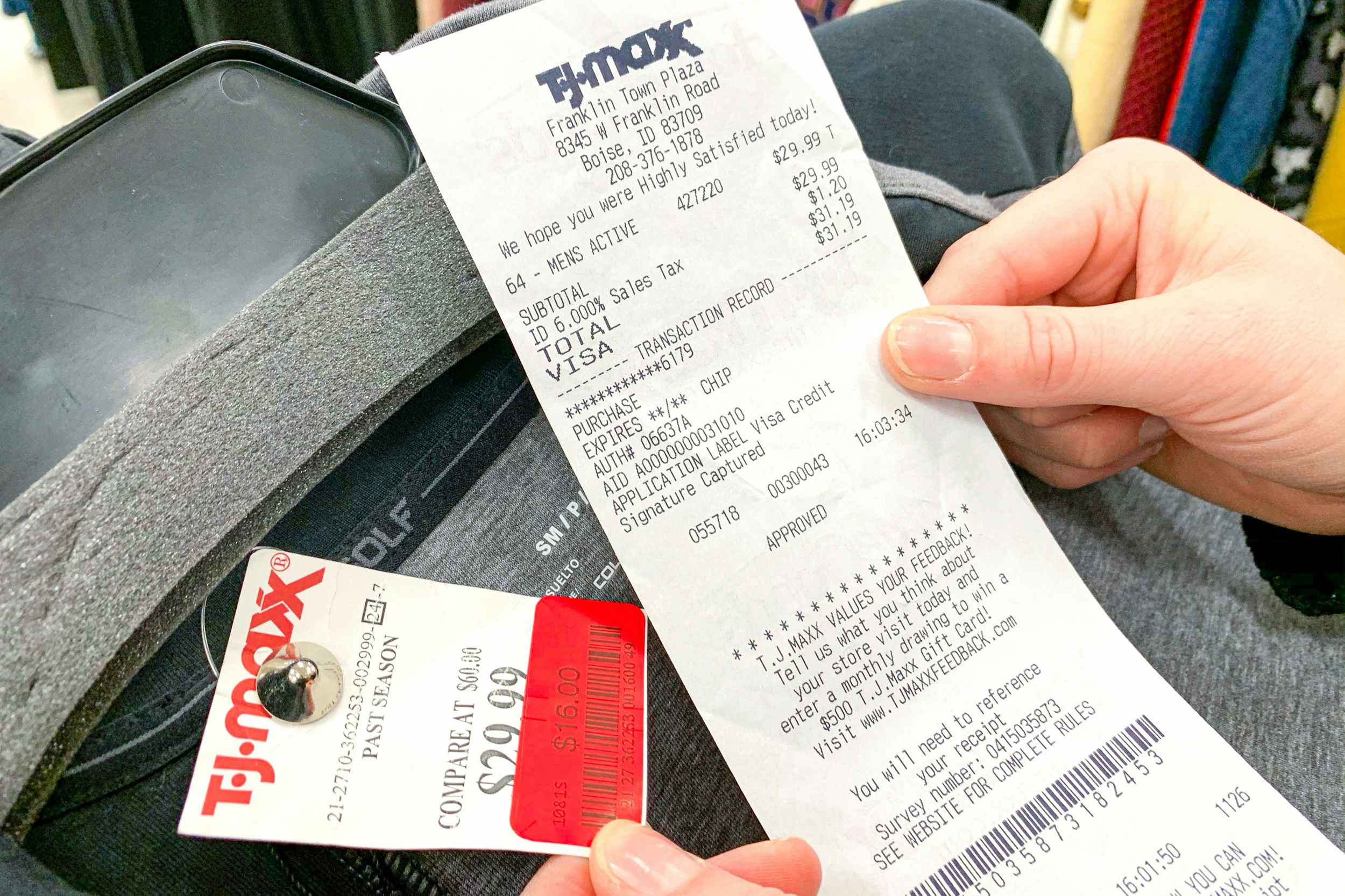 someone holding a tjmaxx receipt next to an item with a price tag