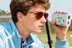 a man using a golf rangefinder