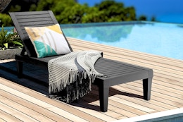 Lifestyle image of the Gymax Outdoor Chaise Lounge Chair set up by a pool