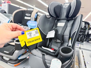 hand holding clearance tag for graco car seat