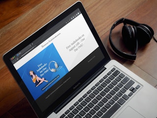 a laptop displaying the Romance Audiobooksworms website displaying an ad for the free audiobook day on August 25th, 2023