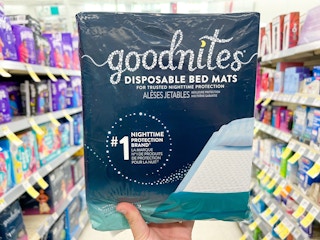 hand holding goodnites bed mats