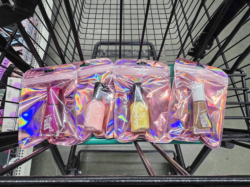4 bags containing sally hansen nail polish in a cart