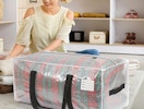 a person folding clothes next to a clear storage bag