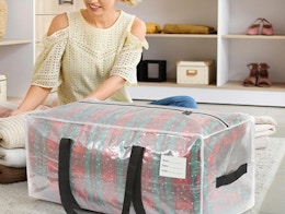 a person folding clothes next to a clear storage bag