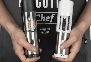 hands holding electric salt and pepper grinders