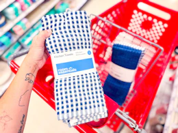hand holding a kitchen towel set in front of parked target cart