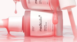 bottles of pink face serums