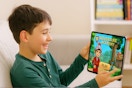 a child playing adventure academy on a tablet 