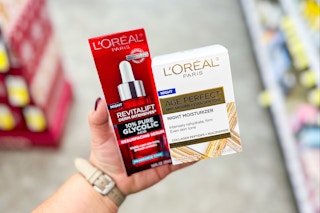 person holding loreal paris skincare products