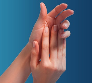 Hands in front of a blue screen.