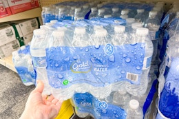 person grabbing a 24-pack of bottled water