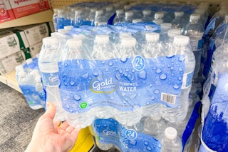 person grabbing a 24-pack of bottled water