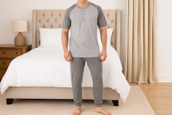 AI image created by ChatGPT of man wearing the Fruit of the Loom sleep set in the color "Grey Heather" in front of a bed