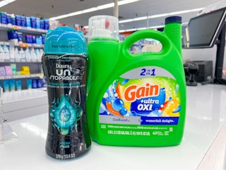bottle of gain liquid detergent and downy scent beads on store counter