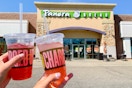 people holding charged lemonade outside of a panera bread