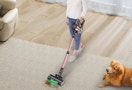 a person vacuuming a floor