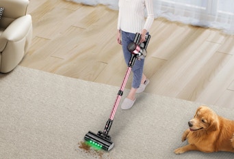 a person vacuuming a floor