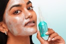 L'oreal exfoliant peel on women's face while she's holding the bottle