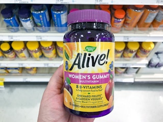 hand holding a bottle of nature's way women's gummy vitamins at target