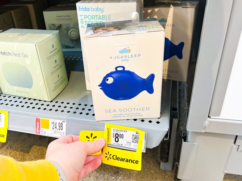 hand holding clearance tag next to Yoga Sleep Sound Machine on walmart shelf