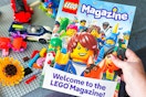 lego magazine being held by a table of legos 