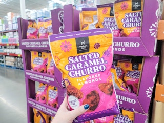 hand holding a bag of salted caramel churro almonds