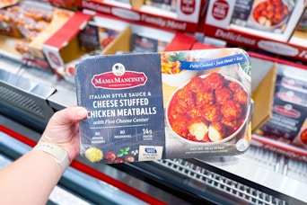 hand holding mama mancini's chicken stuffed meatballs at costco