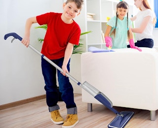 a boy mopping with a spray mop