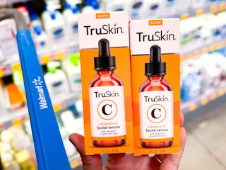 hand holding two truskin vitamin c serums at walmart