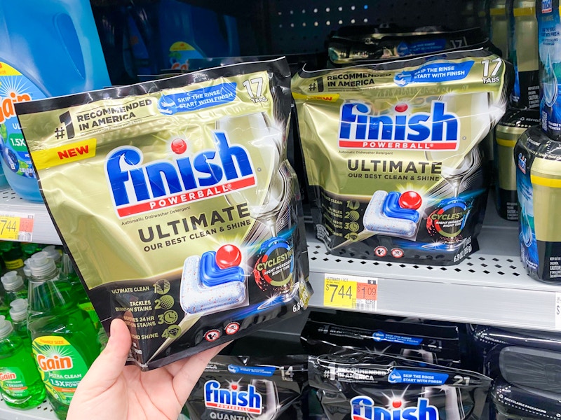 hand holding a bag of finish ultimate tabs next to walmart shelf