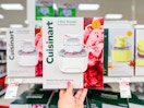hand holding a cuisinart ice cream maker in front of a target shelf