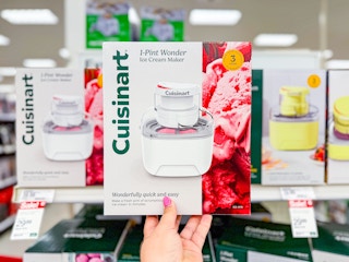 hand holding a cuisinart ice cream maker in front of a target shelf