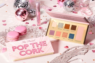 Too Faced Pop The Cork Makeup Set arranged on a party table