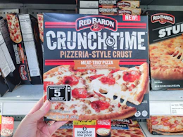 hand holding a red baron pizza