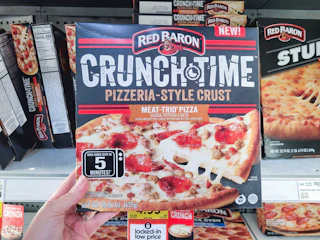 hand holding a red baron pizza