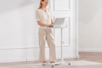 woman standing at portable desk