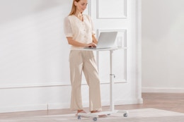woman standing at portable desk