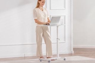 woman standing at portable desk
