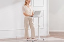 woman standing at portable desk