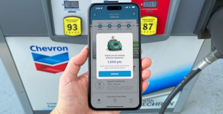 someone holding a phone displaying their Chevron rewards app points earned from downloading and joining
