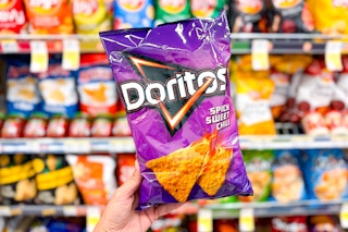hand holding a bag of doritos