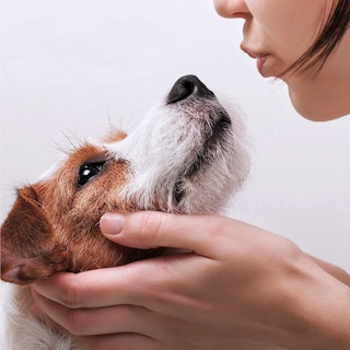 A woman near her small dog.