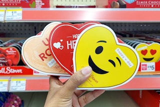 hand holding three Russell Stover heart boxes