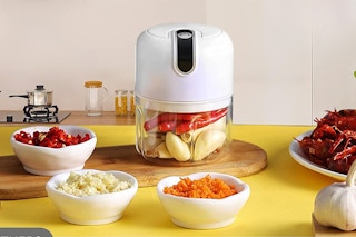 food processor on counter filled with vegetables 