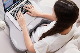 a laptop lap desk being used on a couch