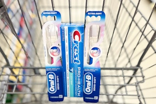 two Oral-B Manual toothbrushes and one box of Crest Pro-Health toothpaste in cart