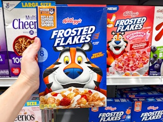 Hand holding a box of Frosted Flakes cereal